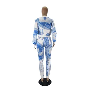 Back view of women's two-piece tracksuit featuring blue US dollar bill print design