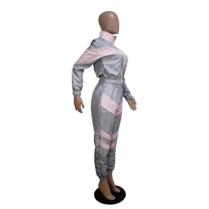 Detail of side profile showing grey and pink color block windbreaker tracksuit set
