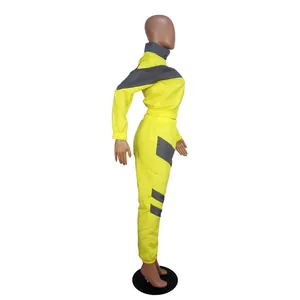 Side view of two-piece yellow and grey patchwork windbreaker tracksuit set for women