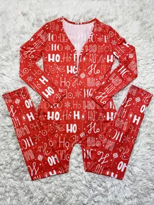 Detailed macro view of the Christmas themed HO HO HO pattern on red festive jumpsuit