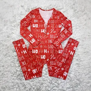 Red festive women's Christmas onesie featuring 'HO HO HO' holiday print on white fur background