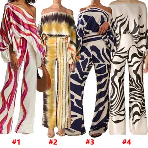 Detail view of four satin off-shoulder top and wide-leg pants sets in various prints
