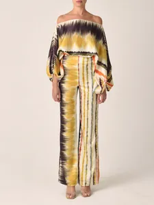 Elegant detail of a fashionable satin printed off-the-shoulder top and pants two-piece set