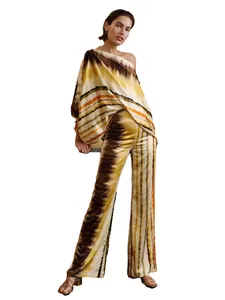 Professional full body shot of a woman in a satin tie-dye set on white background