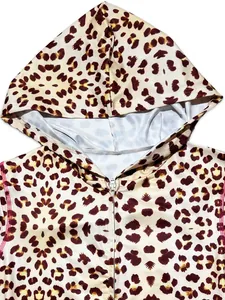 Close-up detail of a fashion leopard print hooded cardigan with front zipper and red stitching