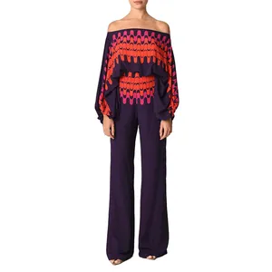 Detail view of stylish satin printed two-piece set with off-shoulder top and wide-leg pants