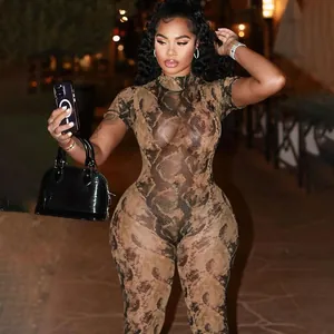 Sexy sheer mesh jumpsuit featuring brown snake skin print worn by a female model outdoors