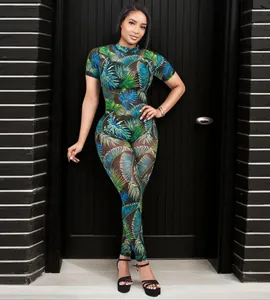 Full body view of a women's sexy palm leaf print see-through mesh jumpsuit outfit