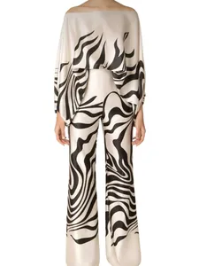 Satin two-piece set with black and white zebra print, off-the-shoulder top and wide trousers