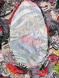 Close-up detail of traditional koi and dragon tattoo print on sheer mesh jumpsuit fabric