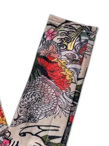 Detailed macro view of vibrant tattoo print patterns on sheer mesh jumpsuit fabric