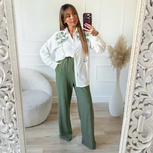Women's chic two-piece set featuring palm print shirt and green wide-leg trousers