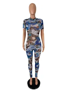 Detailed view of the intricate blue dragon and cloud pattern on a sheer mesh jumpsuit.
