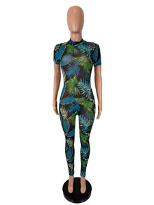 Detail view of tropical leaf print on sheer mesh fabric of a short-sleeved bodysuit jumpsuit