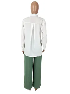 Back view of a casual white long-sleeve shirt and green wide-leg pants set on mannequin