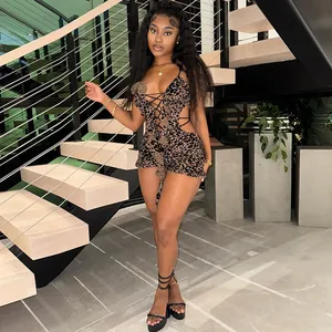 Full-body view of sexy leopard print mesh bodysuit with lace-up front and cut-out details.