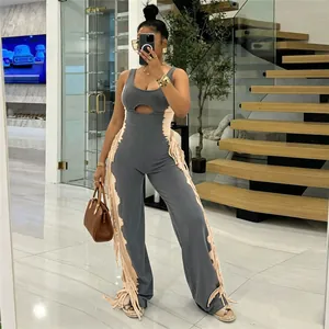 Detail showing two-tone color block design and side fringe tassels on a stylish jumpsuit