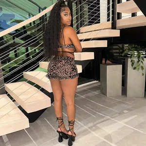 Sexy leopard print mesh two-piece set with cutout tie top and ruffled shorts on stairs