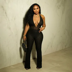 Detail of black lace halter jumpsuit with deep V-neck and open back design