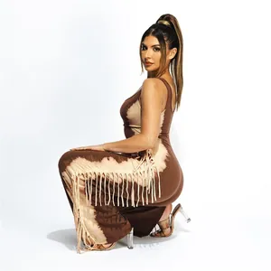 Detailed side view of tie-dye jumpsuit featuring trendy long fringe details on legs