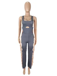 Detailed view of a sleeveless grey jumpsuit with stylish side fringe and waist cutout