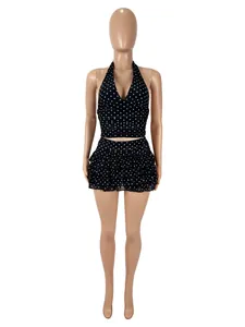 Macro detail of sexy black and white polka dot halter top and ruffled skirt two-piece set