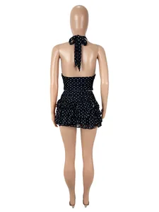 Detailed back view of a sexy black polka dot halter top and ruffled mini skirt set