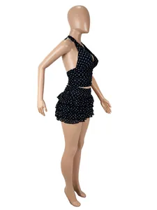 Detailed side view of sexy black polka dot halter crop top and ruffled mini skirt set
