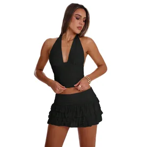 Elegant black halter neck crop top and tiered ruffle mini skirt two-piece set for women