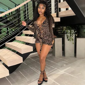 Model wearing a sexy leopard print long-sleeve mesh bodysuit with lace-up front details