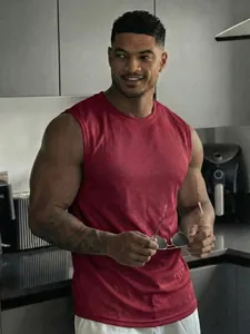 Detail showing the dark red breathable mesh fabric and fit of the men's sports gym tank top