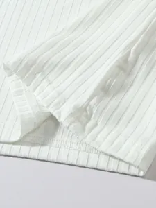 Close-up macro view of high-quality white ribbed fabric texture and hem stitching on men's vest