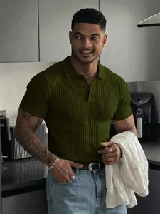 Men's slim fit olive green ribbed short sleeve polo shirt in lifestyle kitchen setting