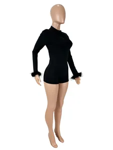 Side view of black backless long sleeve bodysuit with feather cuffs on mannequin