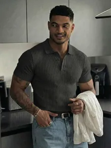 Close-up of a men's ribbed knit polo shirt with button collar in a casual setting