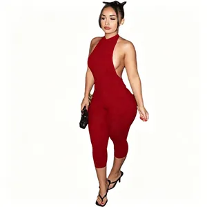 Full body view of the red backless jumpsuit showing the sexy halter neck detail
