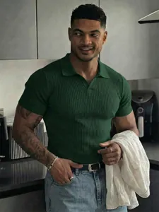 Detailed view of the dark green ribbed texture and V-neck of this slim fit men's polo