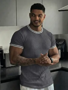 Macro detail showing the ribbed texture and striped collar of this men's grey T-shirt.
