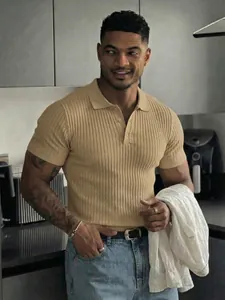 Detail of men's ribbed knit polo shirt showing a slim fit in beige with buttoned collar.
