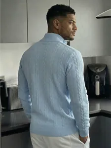 Primo piano della schiena e del profilo laterale di un maglione a trecce azzurro da uomo.