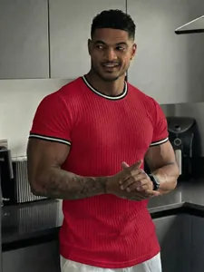 Close-up of red ribbed men's sports t-shirt showing collar and cuff stripe detail
