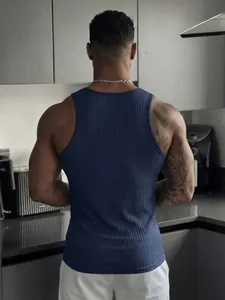 Back view detail of a men's navy blue ribbed muscle tank top in a modern kitchen.