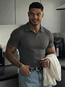 Close-up of a muscular man wearing a grey ribbed V-neck slim fit Polo shirt