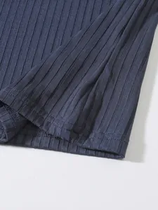 Close-up showing the ribbed fabric texture and stitching of the men's navy blue tank top.
