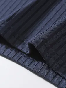 Close-up detail of navy blue ribbed fabric and stitching on men's sports tank top