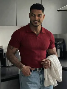 Muscular male model wearing a burgundy ribbed V-neck short sleeve polo shirt