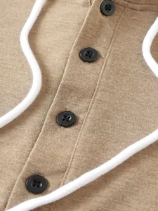 Close-up detail of a brown long sleeve button hoodie with white drawstrings and texture.