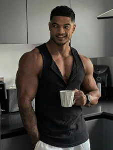 Muscular man wearing a black ribbed fitness tank top with button detail