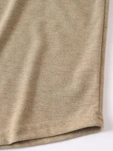 Macro view of khaki fabric texture and double-stitched hem on a casual men's hoodie