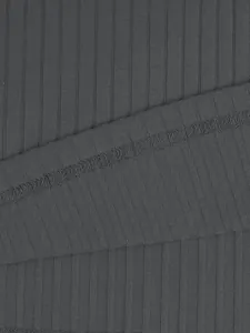 Macro detail of charcoal grey ribbed knit fabric with professional overlock stitching.